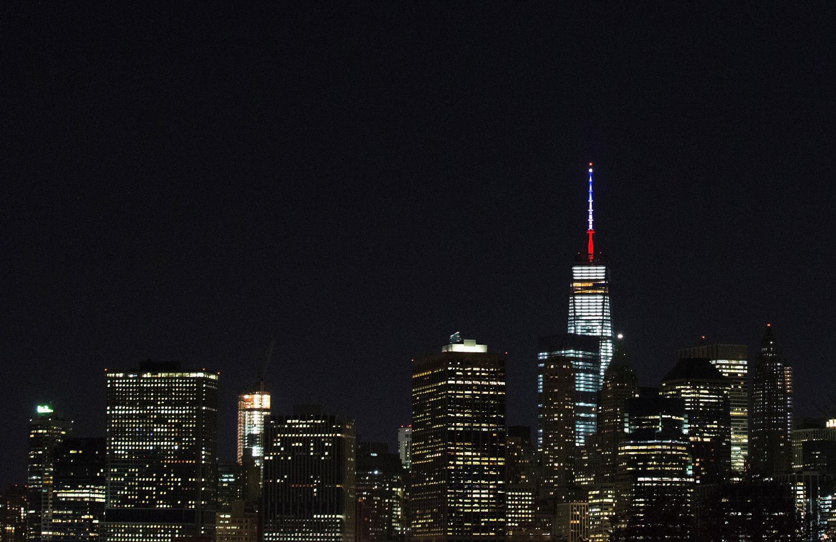 NEW YORK, NY - NOVEMBER 13: One World Trade Center's spire is shown lit in French flags colors of white, blue and red in solidarity with France after tonight's terror attacks in Paris, November 13, 2015 in New York City. According to reports, over 150 people were killed in a series of bombings and shootings across Paris, including at a soccer game at the Stade de France and a concert at the Bataclan theater. (Photo by Daniel Pierce Wright/Getty Images)