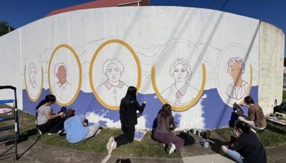 Greeneville High art students make repairs to painted mural they created